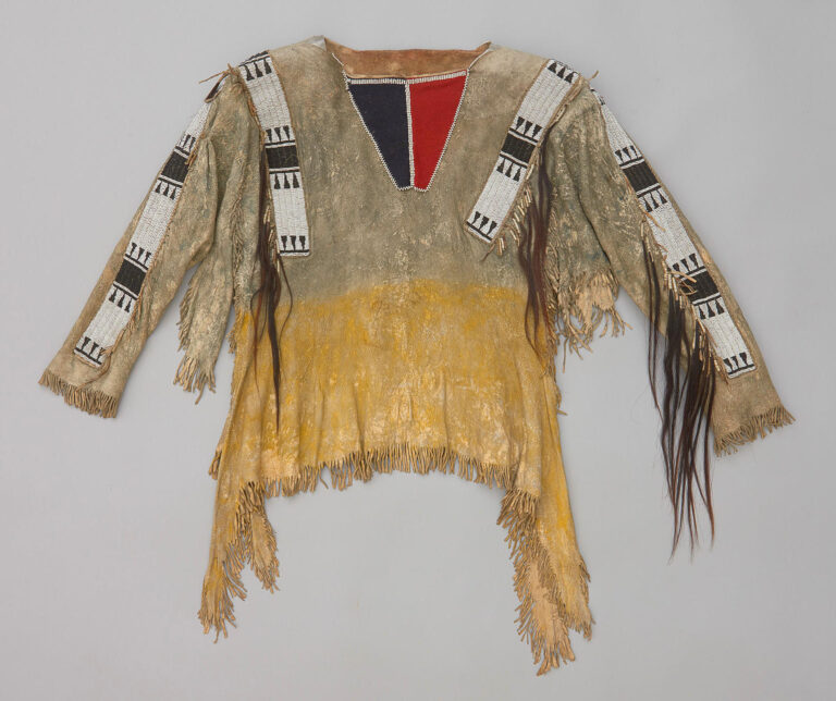 A Cheyenne war shirt with four beaded strips.