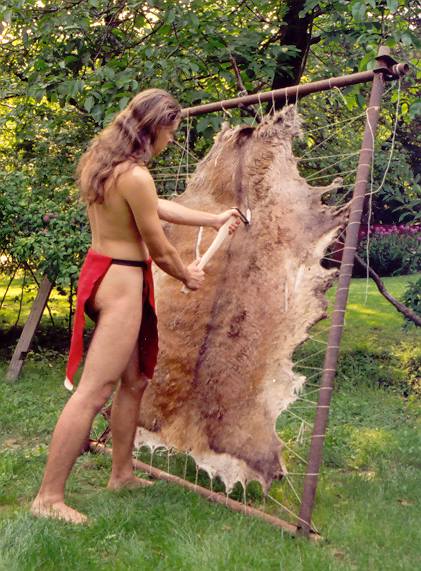 The author of the article dry-scrapes the hair from a dried elk hide laced into a frame.